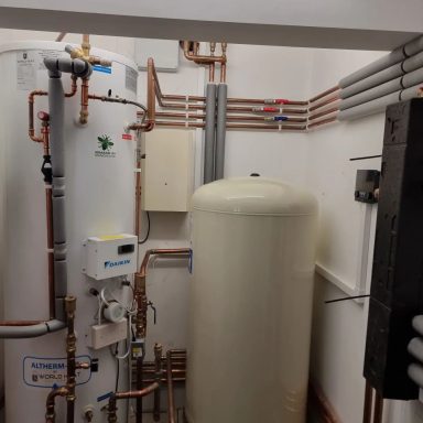 Interior view of a utility room with water heaters and plumbing pipes.